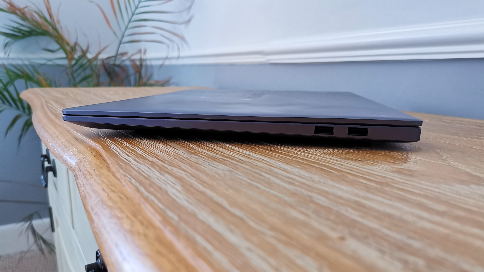 A Huawei MateBook 16 on a table viewed from the side