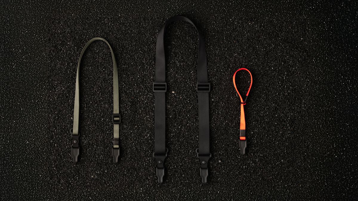 The Wandrd Magnetic Camera strap being used by a photographer