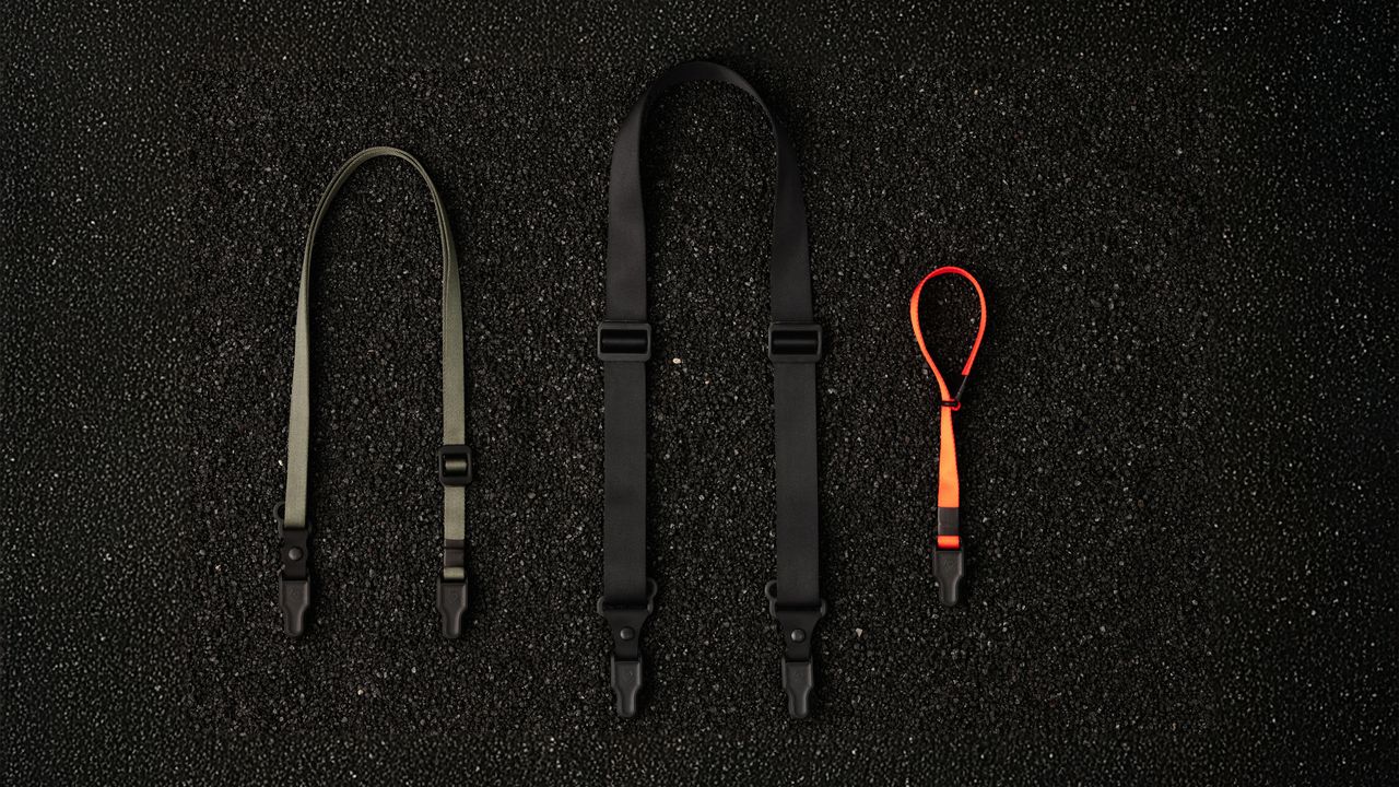 The Wandrd Magnetic Camera strap being used by a photographer
