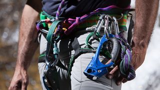 Close up of a climber's harness loaded with gear