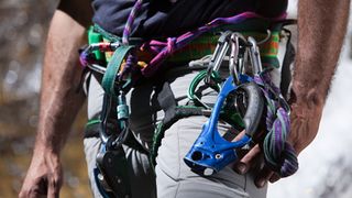 Close up of a climber&#039;s harness loaded with gear