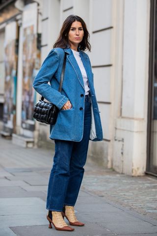 woman wearing denim straight leg jeans with a blazer