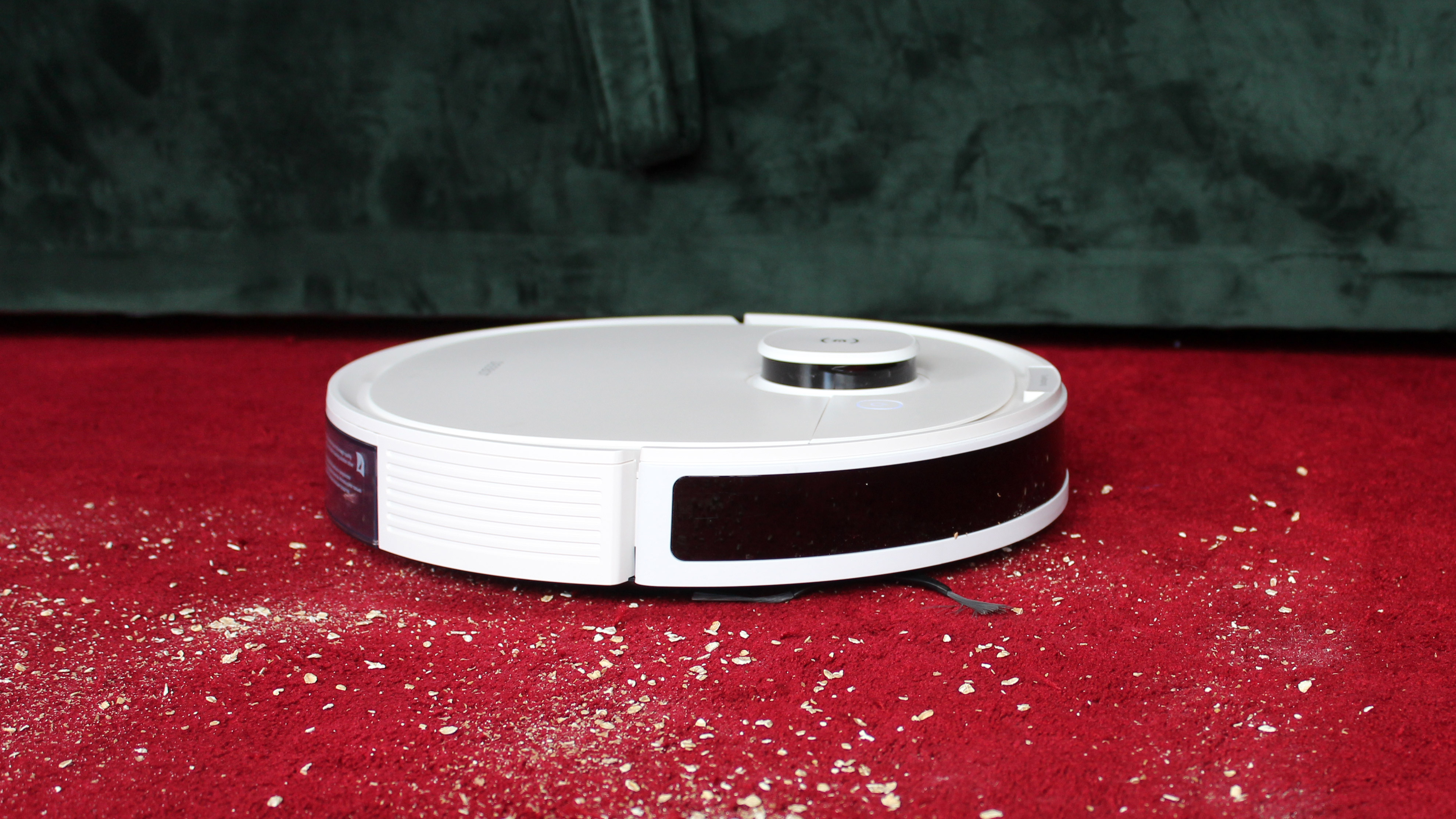 Ecovacs Deebot Ozmo N8+ collecting dust from red carpet