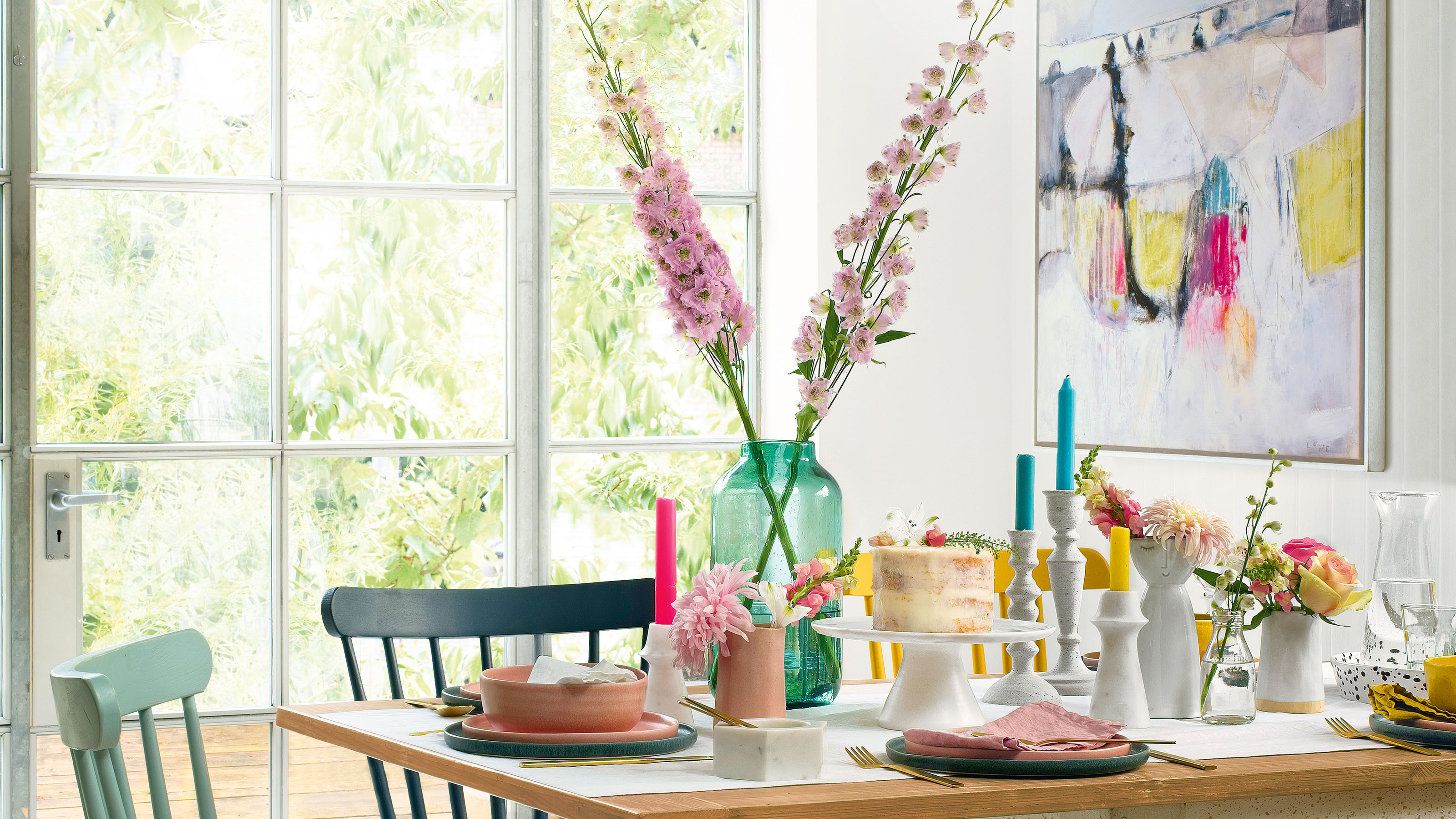 Dining table with cake plates and pastel chairs