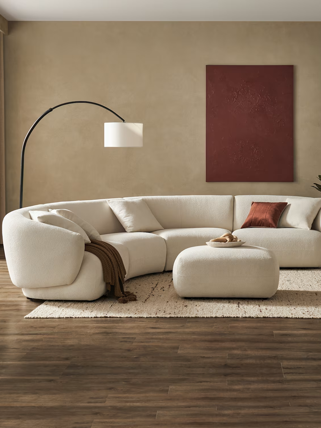 A white curved performance fabric modular sofa from Castlery