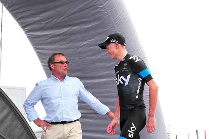 Chris Froome (Team Sky) walks onto the stage two podium after winning atop Col du Beal