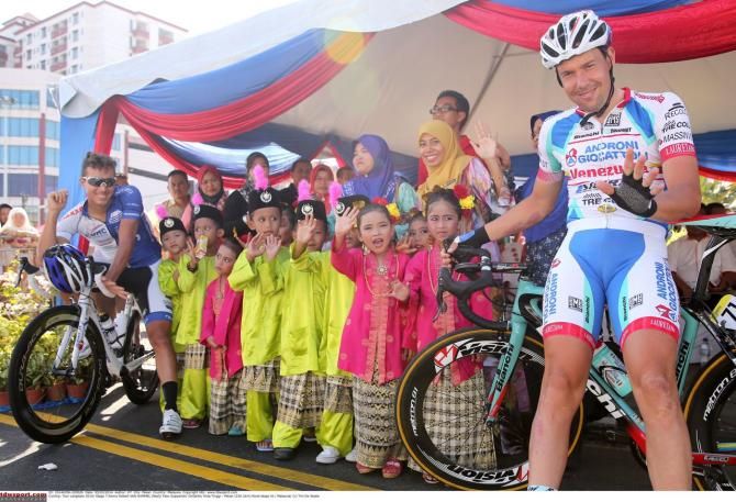 Kenny van Hummel poses with some children
