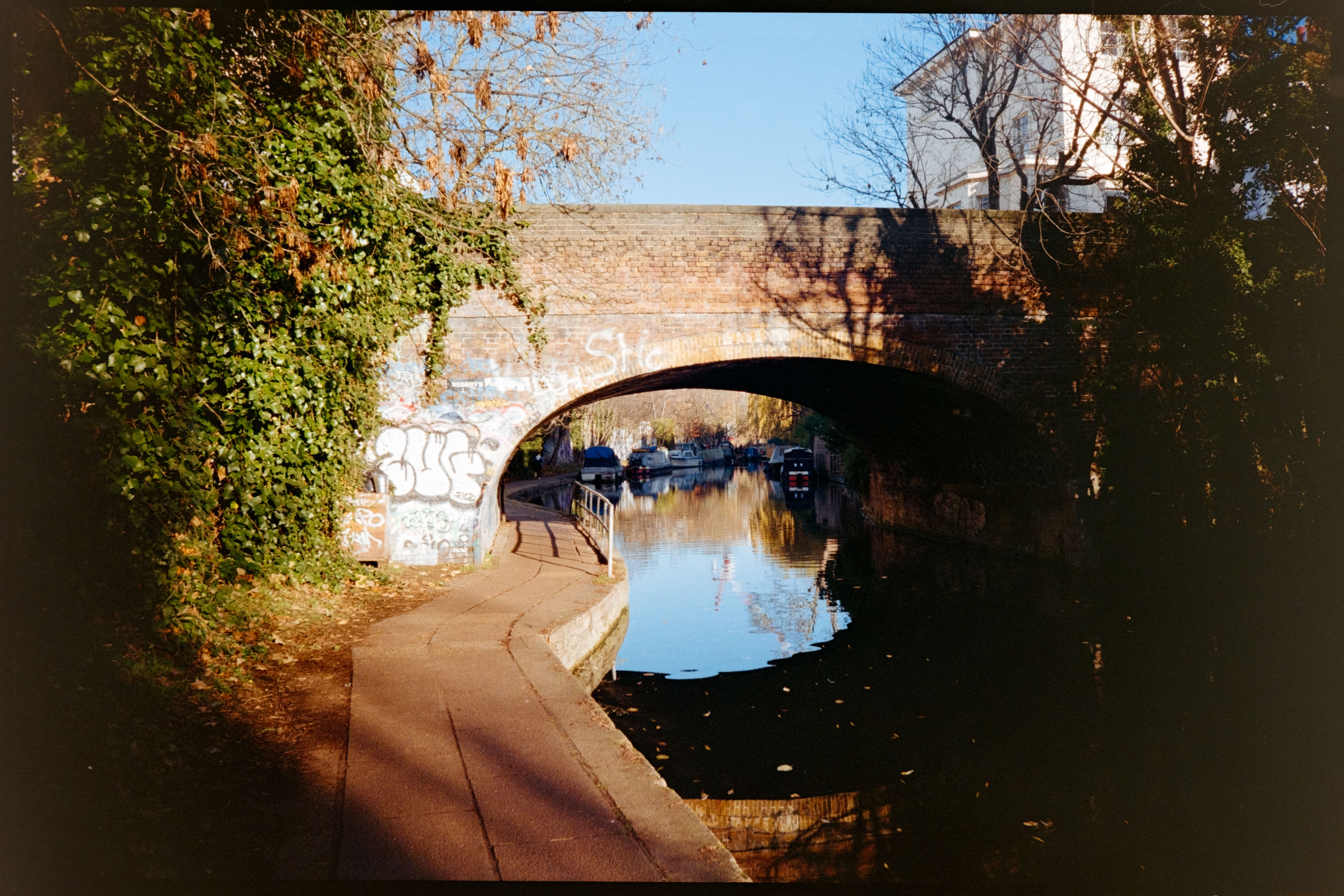 A bridge over a canal in bright sunlight