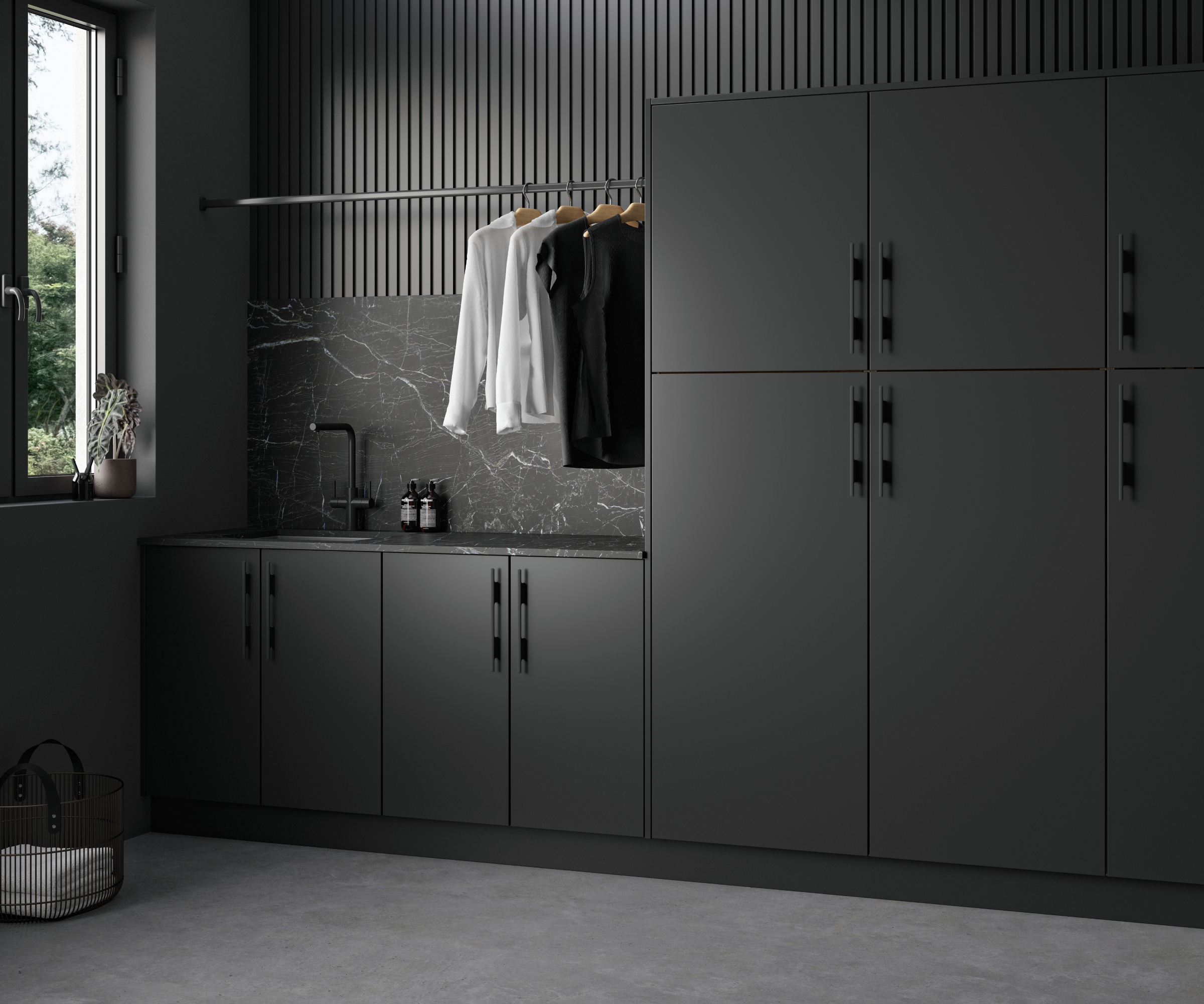 utility room with dark grey modern cabinets, grey floor, window and hanging rail with clothes on above a sink area