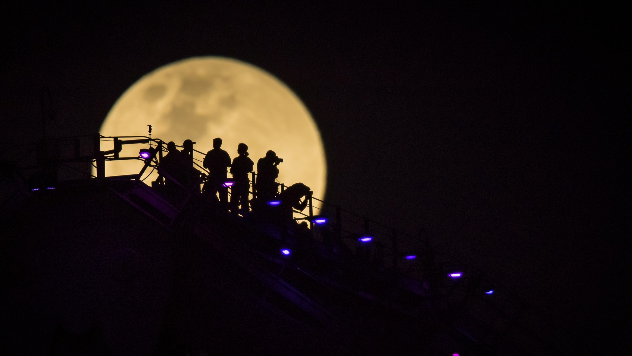 As the Supermoon rises over Brisbane it catches the Story Bridge Climbers in full silhouette.