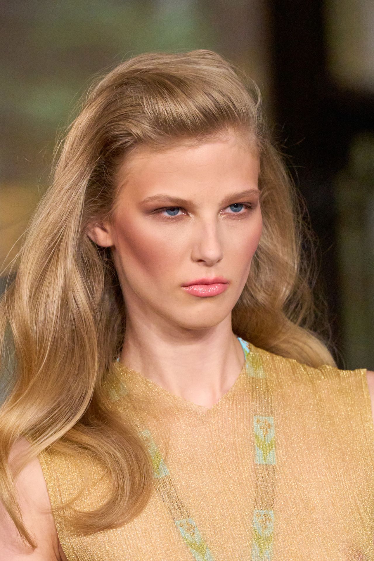 No part at Conner Ives on a model in a sheer yellow top with blonde hair .