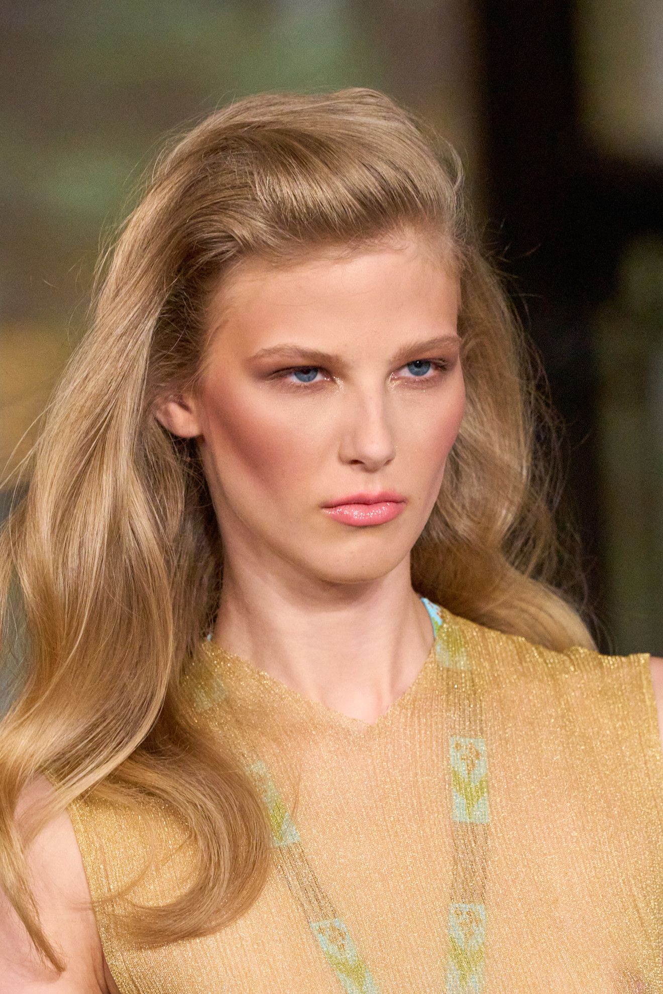 No part at Conner Ives on a model in a sheer yellow top with blonde hair .