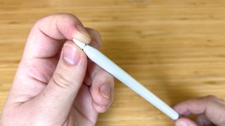An Apple Pencil with the nib partially unscrewed