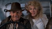 Harrison Ford as Indiana Jones flying a plane with Kate Capshaw looking stressed out in Temple of Doom.