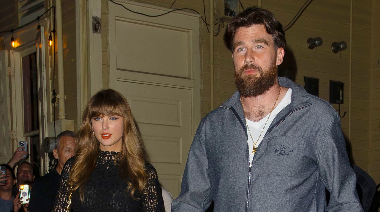 Taylor Swift wears a black lace dress with black laced boots and holds hands with boyfriend Travis Kelce ahead of the 2025 Super Bowl in New Orleans