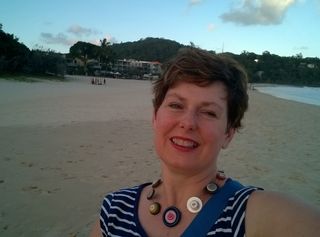 A woman takes a selfie on a beach