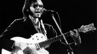 Neil Young performing live on stage at Wembley Stadium on 14th September 1974 using a Gretsch White Falcon