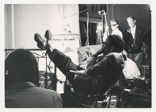 Bergman with his feet on the bed where he films a scene in which Anna masturbates