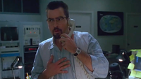 a worried man on a telephone