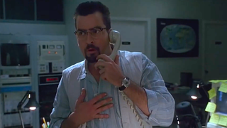 a worried man on a telephone