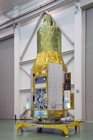 The ASTRO-H spacecraft as it appeared on Nov. 27, 2015, at Tsukuba Space Center in Japan. The open compartment visible at lower left houses the Soft X-ray Spectrometer.