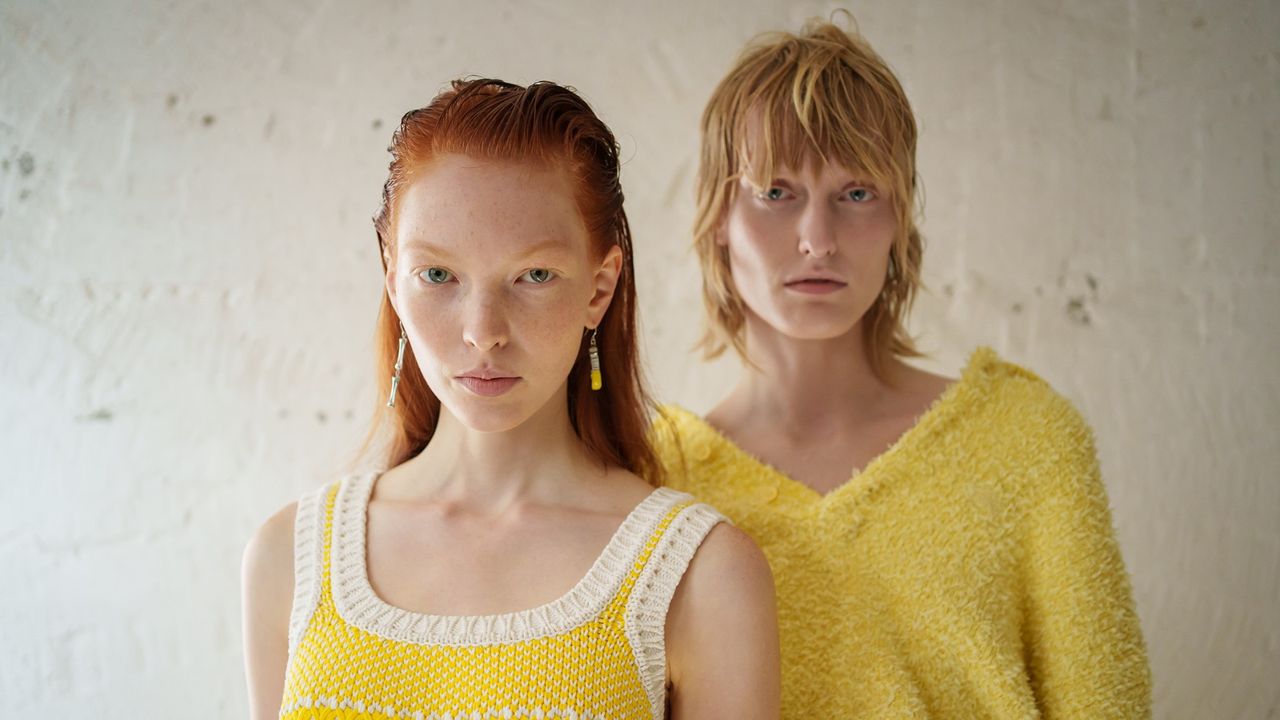 two women wearing knitted tops wearing beef tallow on their skin