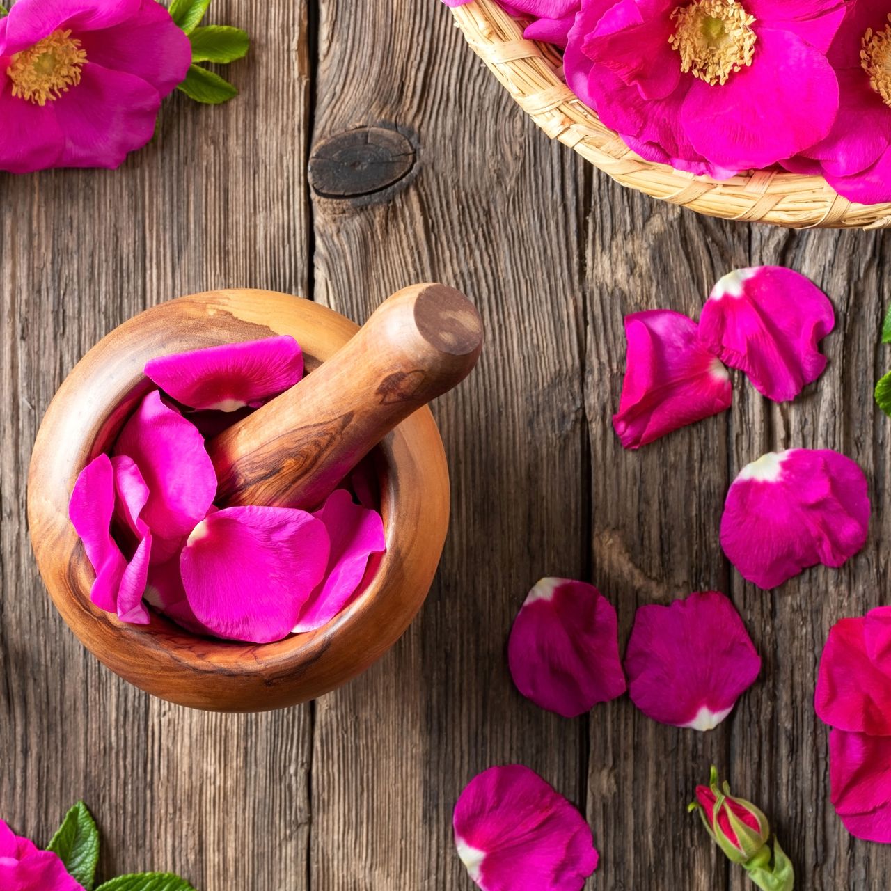 pink rose petals and pestle and mortar on table
