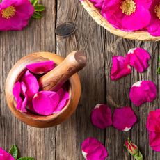pink rose petals and pestle and mortar on table