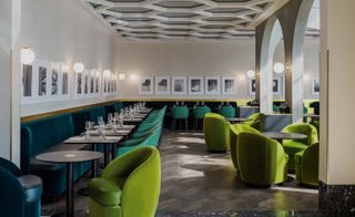 Suede blue booths, green chairs and tables line the walls