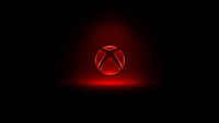 A glowing red Xbox logo sits centered on a black background, surrounded by a soft red light with a faint reflection beneath it.