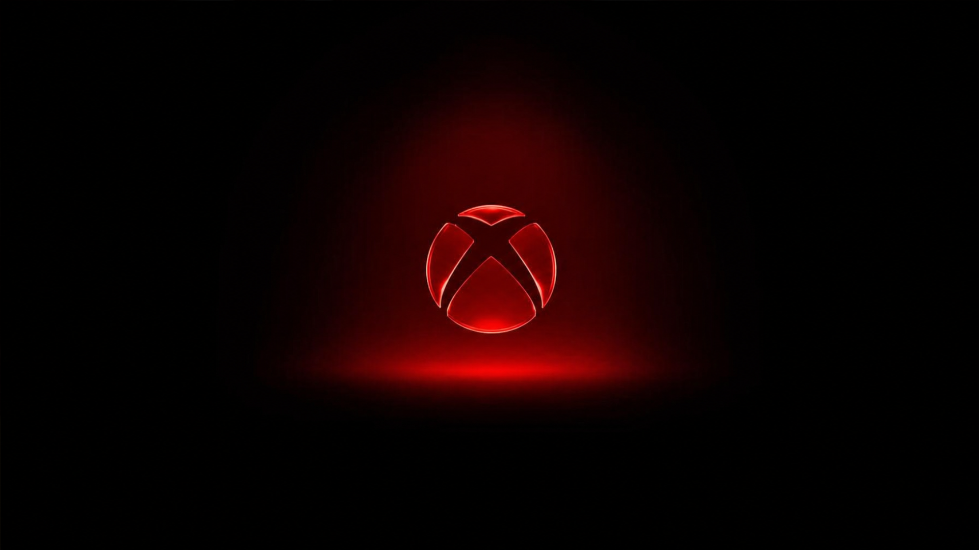A glowing red Xbox logo sits centered on a black background, surrounded by a soft red light with a faint reflection beneath it.