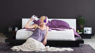 Casper vs Purple: a woman sat leaning against The Purple Mattress