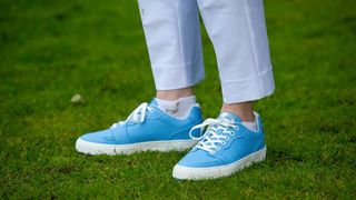 Duca del Cosma Giordana Golf Shoe in a blue colorway resting on the golf course