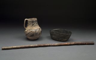 Pottery and a wooden flute found in the graves of the elite individuals at Pueblo Bonito.