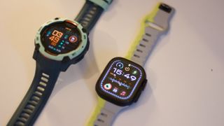 Garmin Instinct 3 next to the Apple Watch Ultra 2