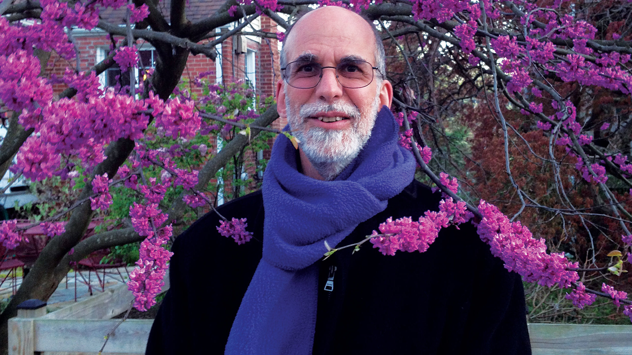 Cuneiform Records&#039; Steve Feigenbaum poses against some pink blossom