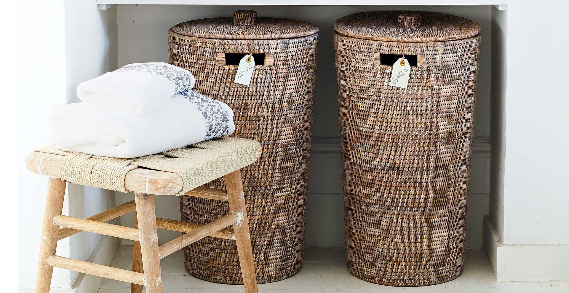 woven laundry baskets labeled for whites and darks to sort colors to demonstrate a n efficent laundry room organization idea