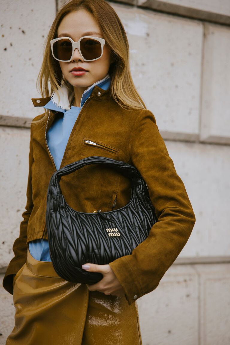 a fashion week guest wearing bug eye sunglasses