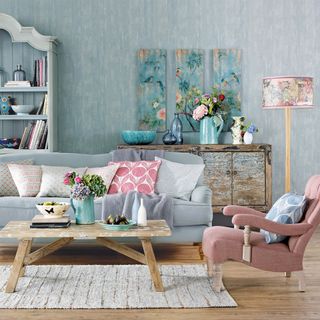 A duck egg living room with patterned wallpaper duck egg sofa and pink armchair