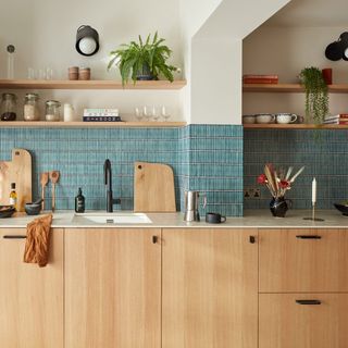 Wood kitchen with slab doors and blue tiles