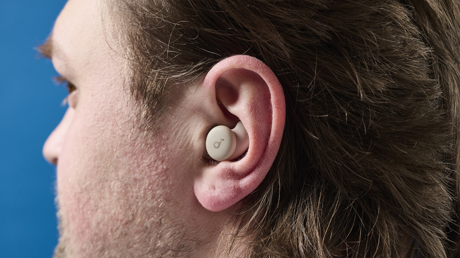 A photo of the Soundcore Sleep A20 earbuds in ear.