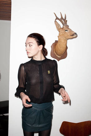 Female wearing thin black long sleeved top and skirt
