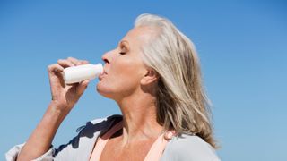 Woman drinking probiotic