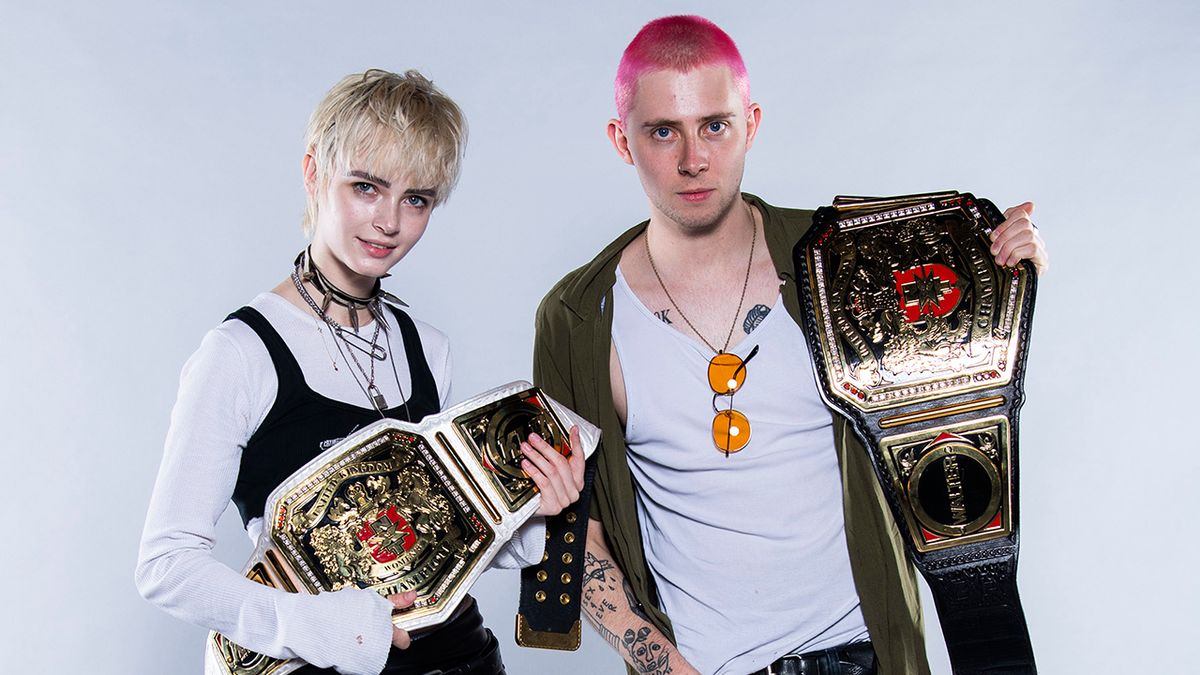 Wargasm holding wrestling belts