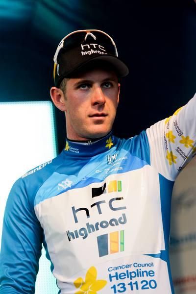 Matt Goss salutes the crowd on the podium.