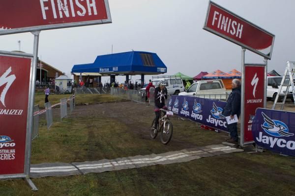 Rowena Fry celebrates victory in the short track in awful conditions at Mt. Buller