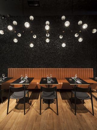 Campo Restaurant in Poland with black walls, table and chairs with wooden floors