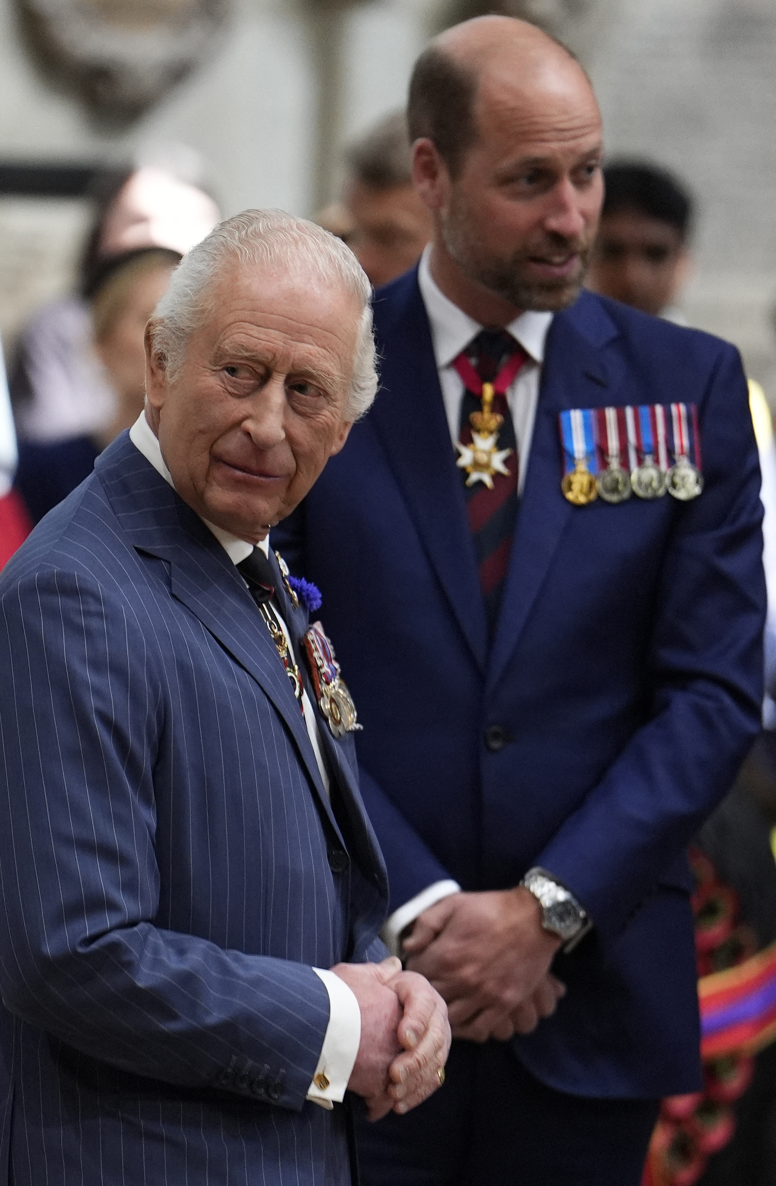 King Charles and Prince William wearing blue suits and medals