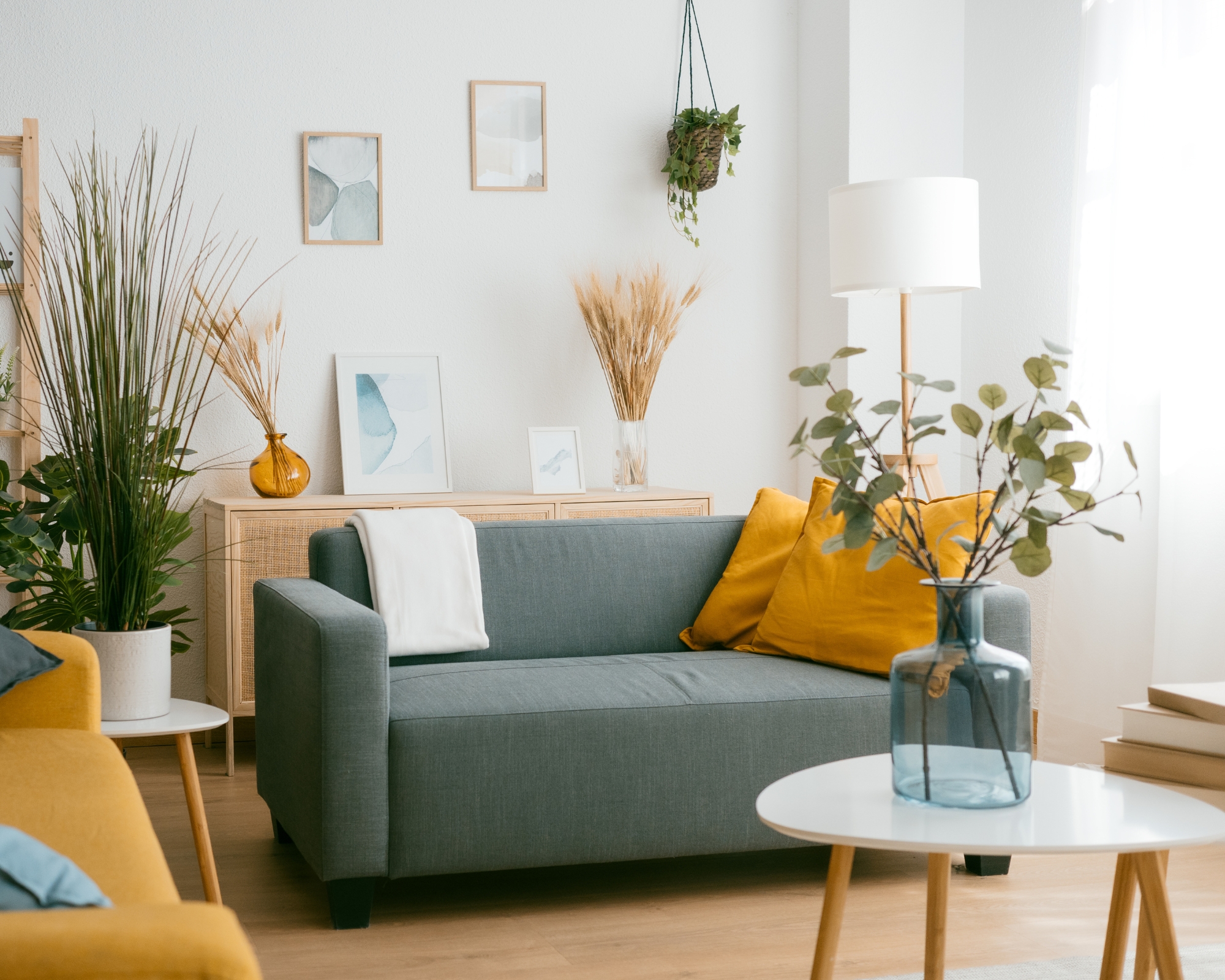 Modern living room with small comfy sofa with big orange cushion