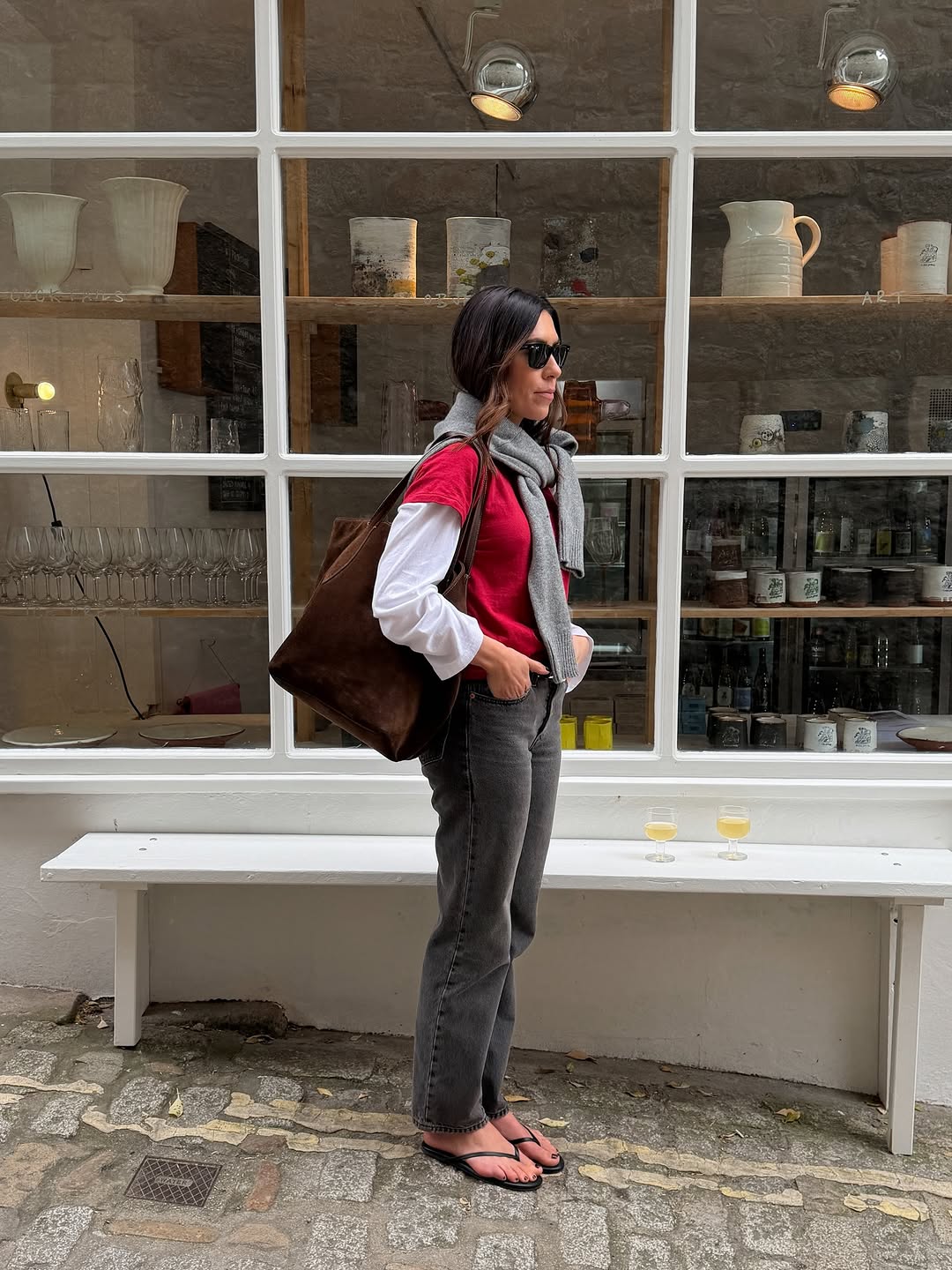 A woman wearing layered t-shirt and jeans, part of spring basics outfits 2026.